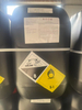 Black drum of nitric acid, corrosive hazardous material